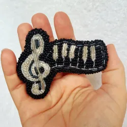 Broche temática musical