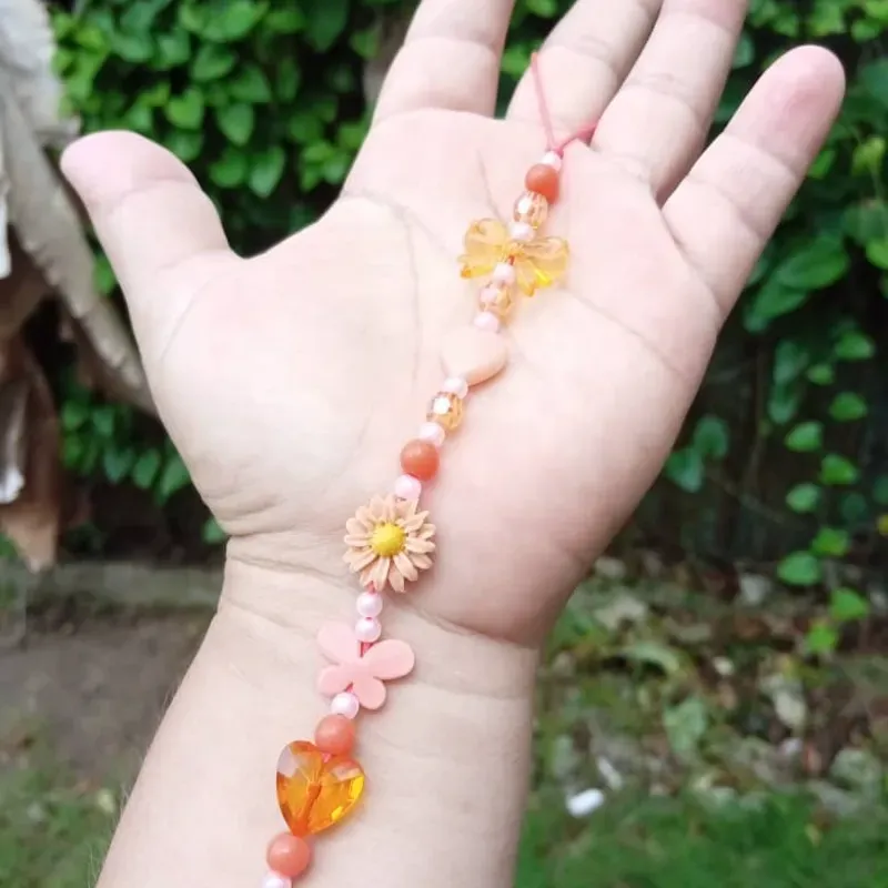Colgante naranja con flor