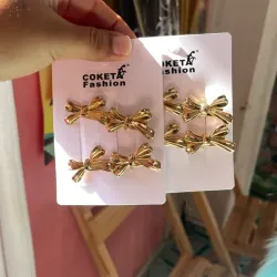 Set de 4 hebillas doradas forma de moño