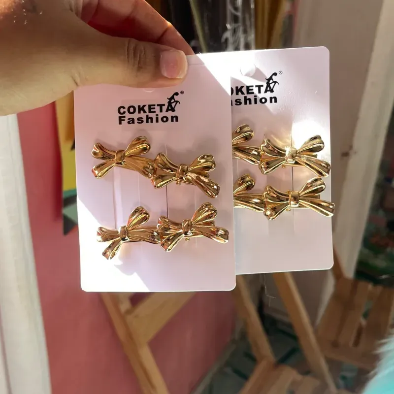 Set de 4 hebillas doradas forma de moño