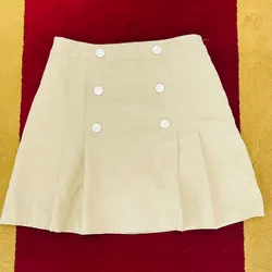 Saya beige estilo porrista con detalles plateados