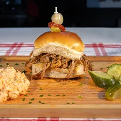 Deluxe pulled pork sandwich World2100,0 famous BBQ pork sauce, onion, slaw on the side.