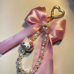 Colgante con lazo rosa , charm en cerámica y broche dorado en corazón 
