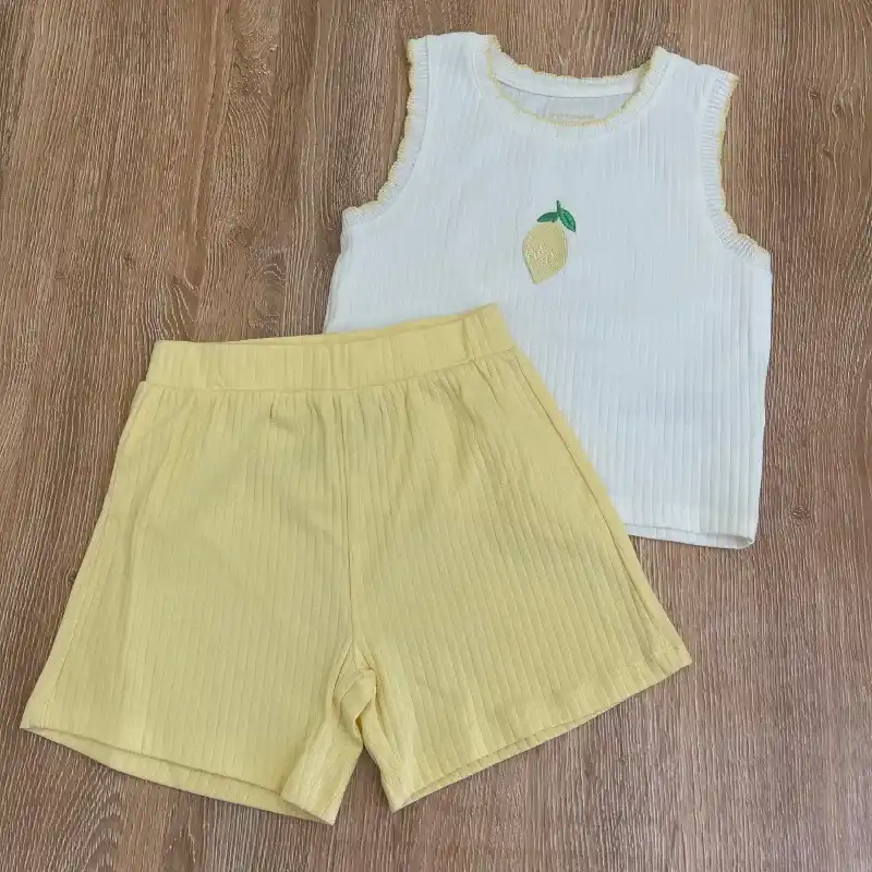 Conjunto color amarillo y blanco con limón en el centro 