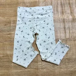 Legging blanco con lazos negros