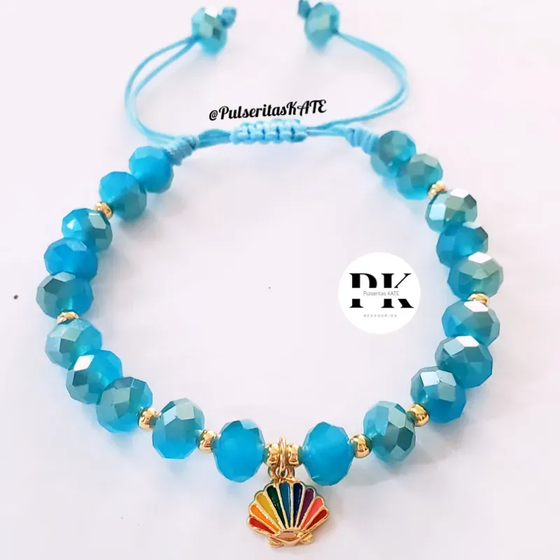 PULSERA DE SWAROVSKI AZUL CON DIJE DE CONCHA