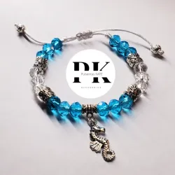 PULSERA DE SWAROVSKI AZUL Y TRANSPARENTE  CON DIJE DE CABALLITO DE MAR