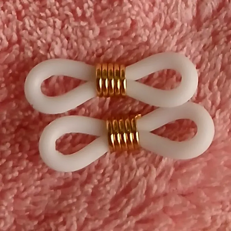 Gomas de espejuelos blanco con herraje dorado
